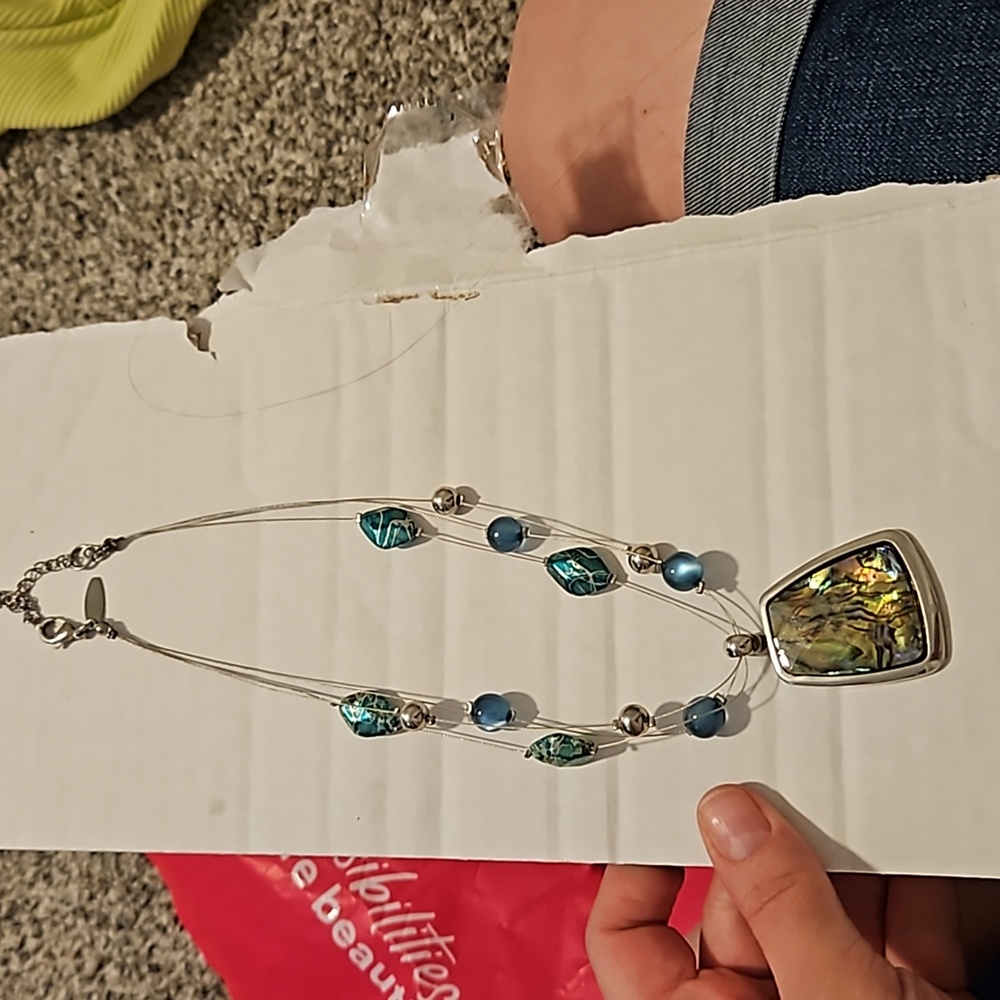 Green and silver necklace. Adjustable size. Great way to dress up an old outfit.